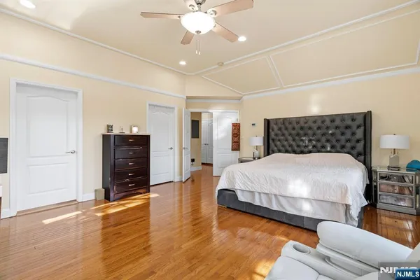 a bedroom with a bed and a chandelier