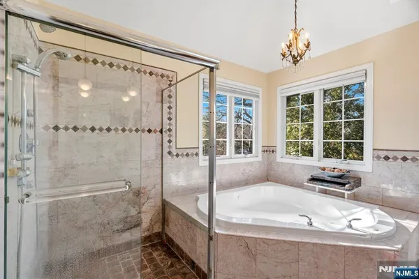 a bathroom with a tub shower and sink