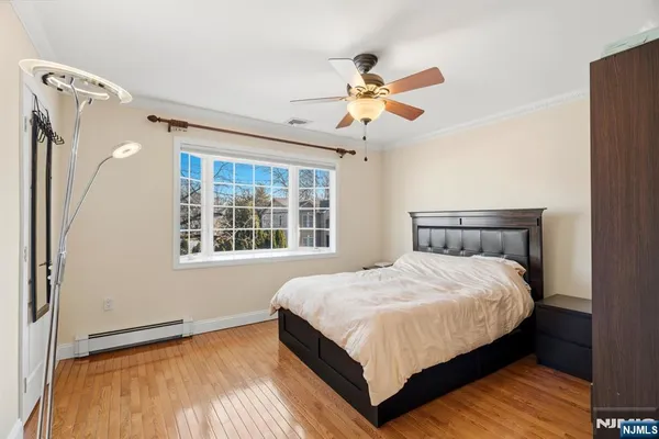 a large bed sitting in a bedroom next to a window