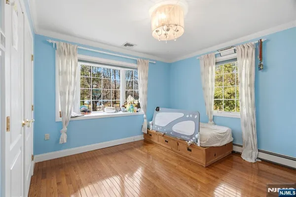 a spacious bedroom with a bed and a window