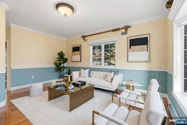 a living room with furniture and a potted plant