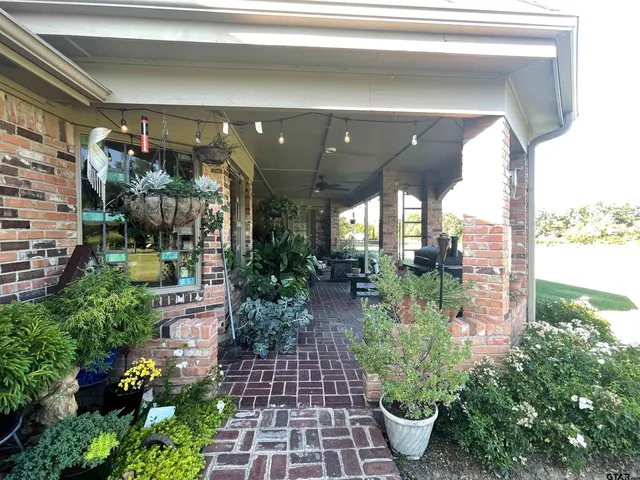a view of a green field with wooden fence