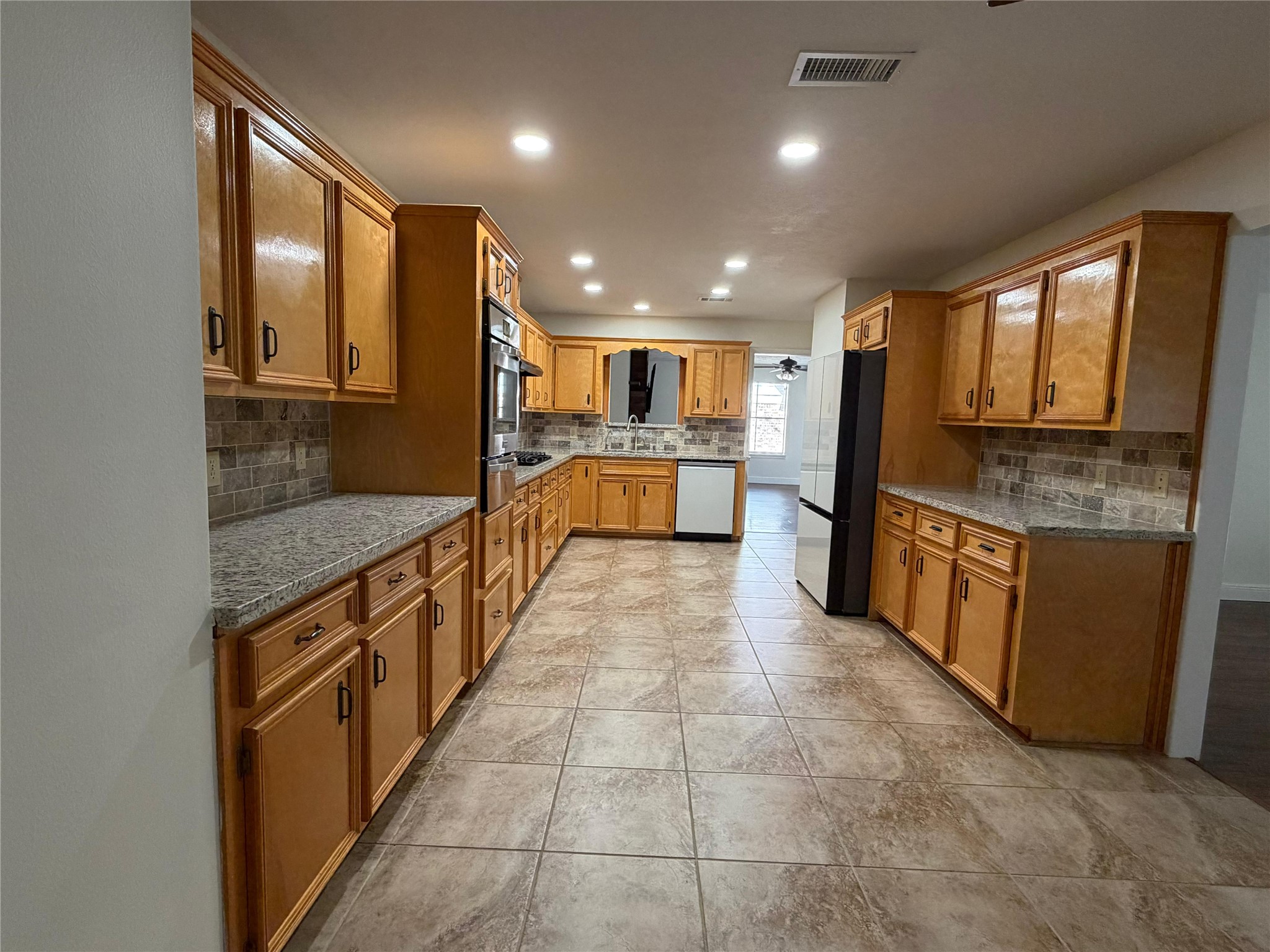 7818 King Arthur Court Spring, TX 77379 - Photo 22 of 29 a large kitchen with a large counter top appliances and cabinets