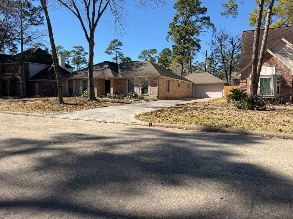 7818 King Arthur Court Spring, TX 77379 - Photo 25 of 29 a front view of a house with a yard