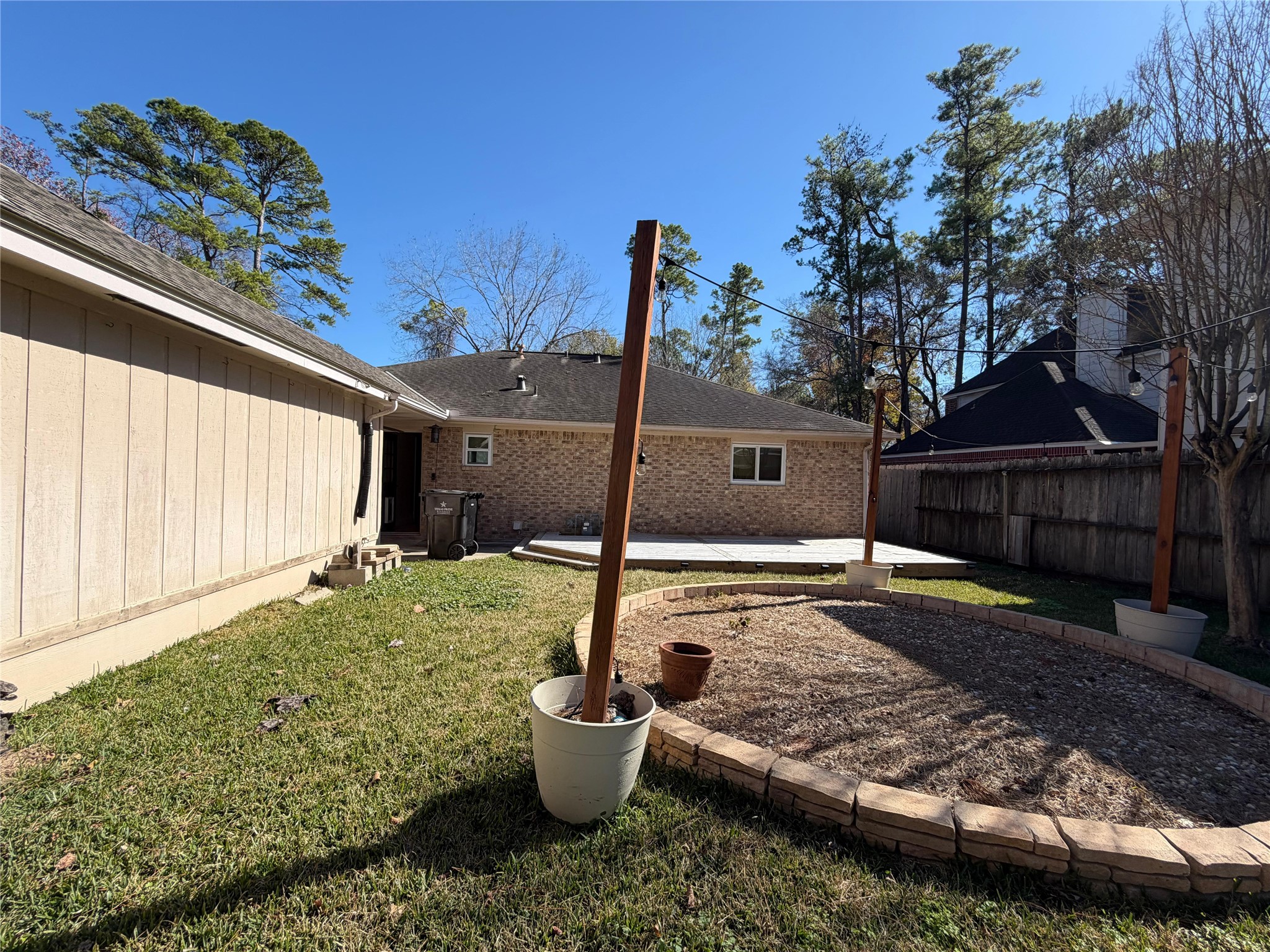 7818 King Arthur Court Spring, TX 77379 - Photo 3 of 29 a view of a backyard with table and chairs potted plants and wooden fence