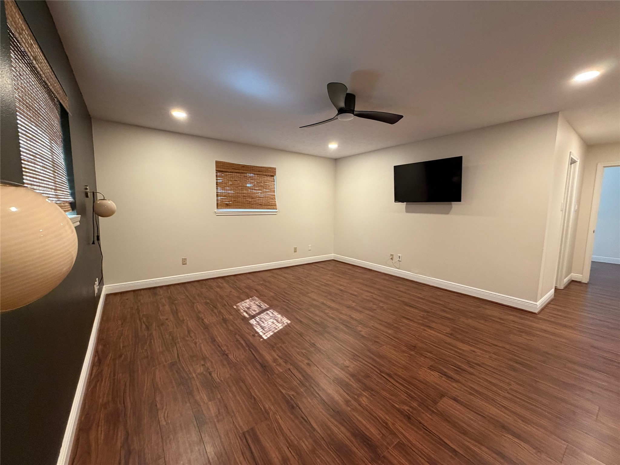7818 King Arthur Court Spring, TX 77379 - Photo 8 of 29 an empty room with wooden floor and windows