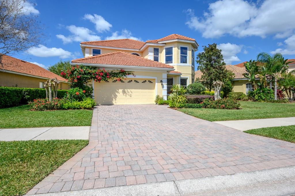 18034 Java Isle Drive Tampa, FL 33647 - Photo 1 of 1 Front view of the house: Paved driveway, professional landscape, barrel tile roof.