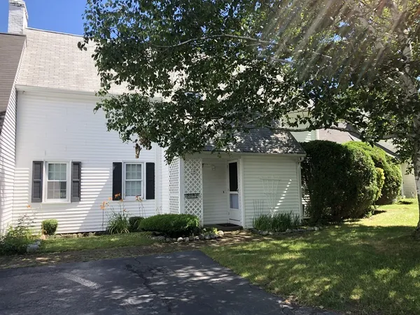a house that has a tree in front of the house