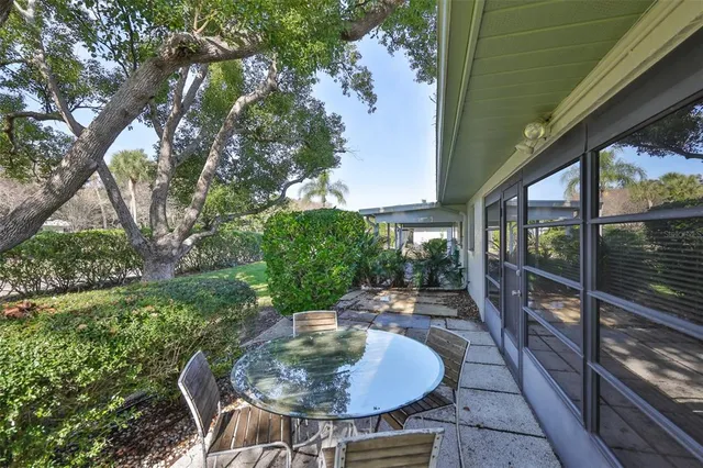 a backyard of a house with table and chairs