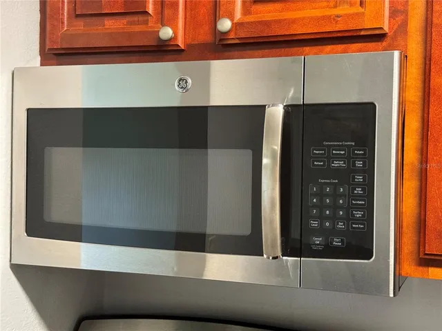 an empty room with a window and a ceiling fan