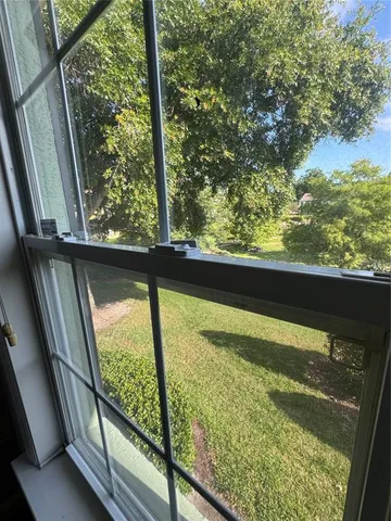 an empty room with closet and windows