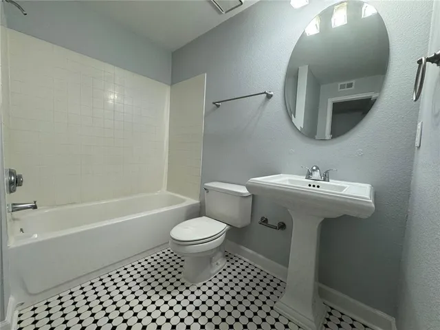 a bathroom with a toilet sink and shower