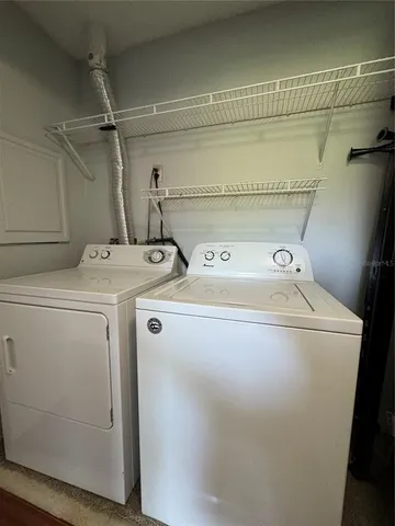 an empty room with ceiling fan and windows