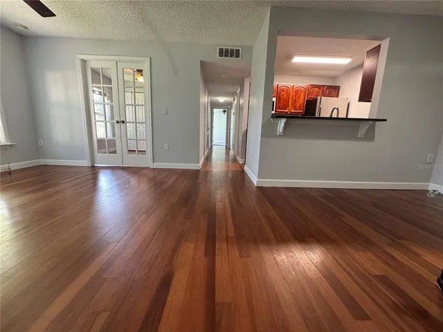 wooden floor in a hall with a window