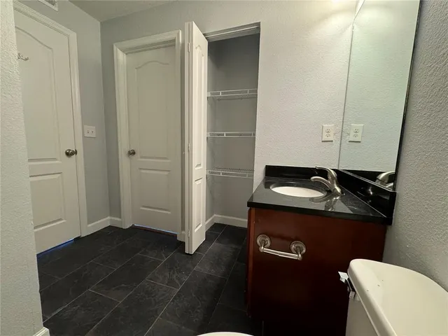 a bathroom with a sink a toilet and a mirror