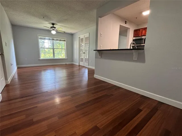 a view of hallway with stairs and wooden floor