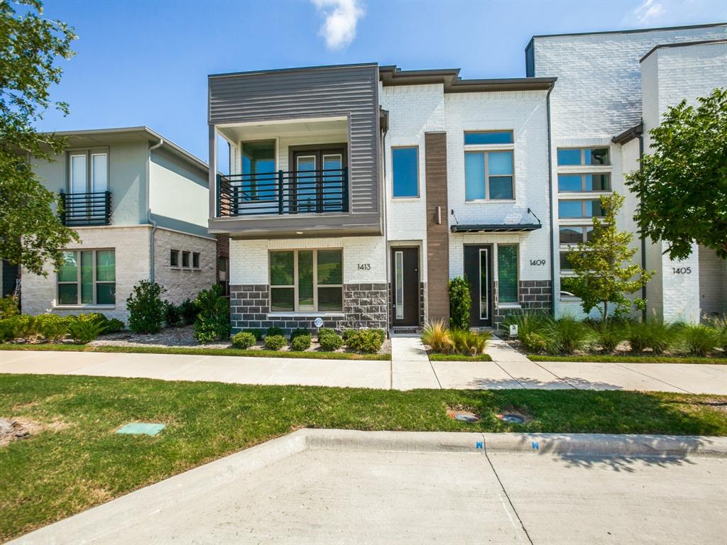 front view of a brick house with a yard
