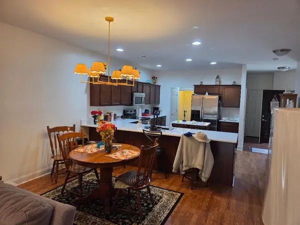 a kitchen with a dining table and chairs