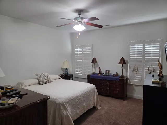 a bedroom with a bed and a dresser