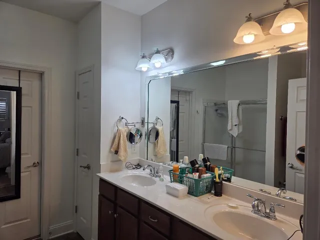 a bathroom with double sink and a mirror
