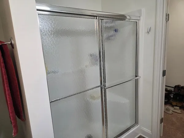 a bathroom with a glass shower door