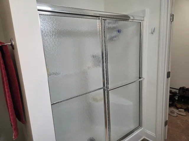 a bathroom with a glass shower door