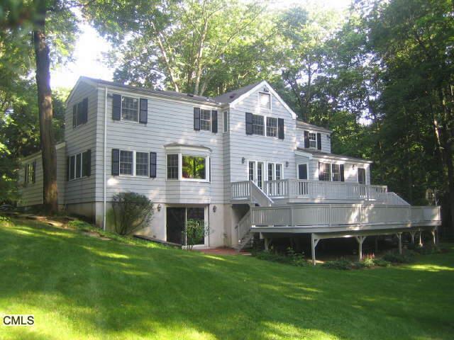 38 Frontier Road Greenwich, CT 06807 - Photo 1 of 1 a front view of house with yard and green space