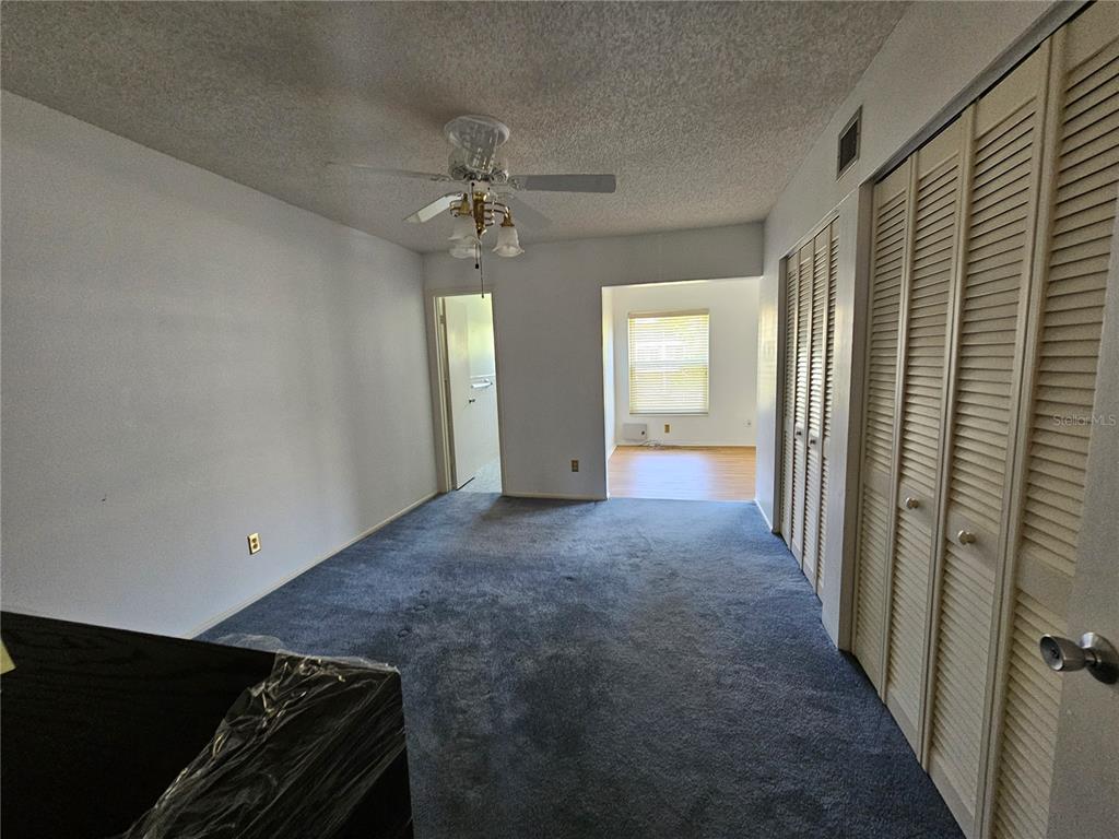 2386 Sumatran Way, Unit 44 Clearwater, FL 33763 - Photo 12 of 67 wooden floor in an empty room with a window