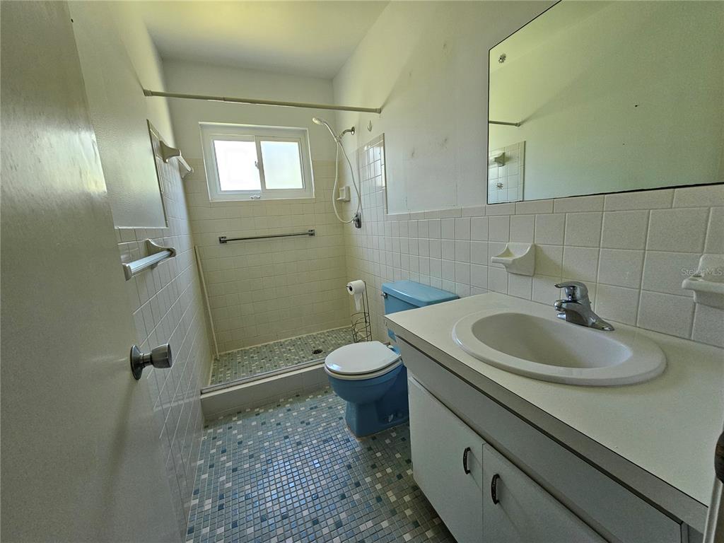 2386 Sumatran Way, Unit 44 Clearwater, FL 33763 - Photo 14 of 67 a bathroom with a sink toilet and shower