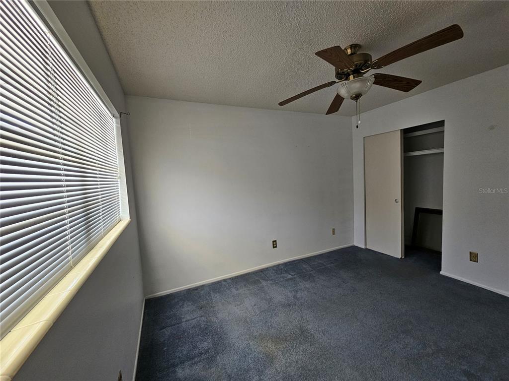 2386 Sumatran Way, Unit 44 Clearwater, FL 33763 - Photo 16 of 67 an empty room with a ceiling fan and a window