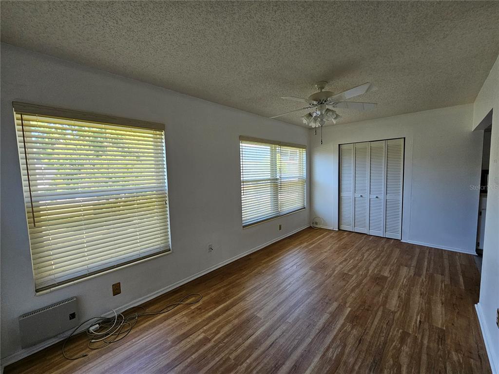 2386 Sumatran Way, Unit 44 Clearwater, FL 33763 - Photo 19 of 67 a view of an empty room with a window and wooden floor