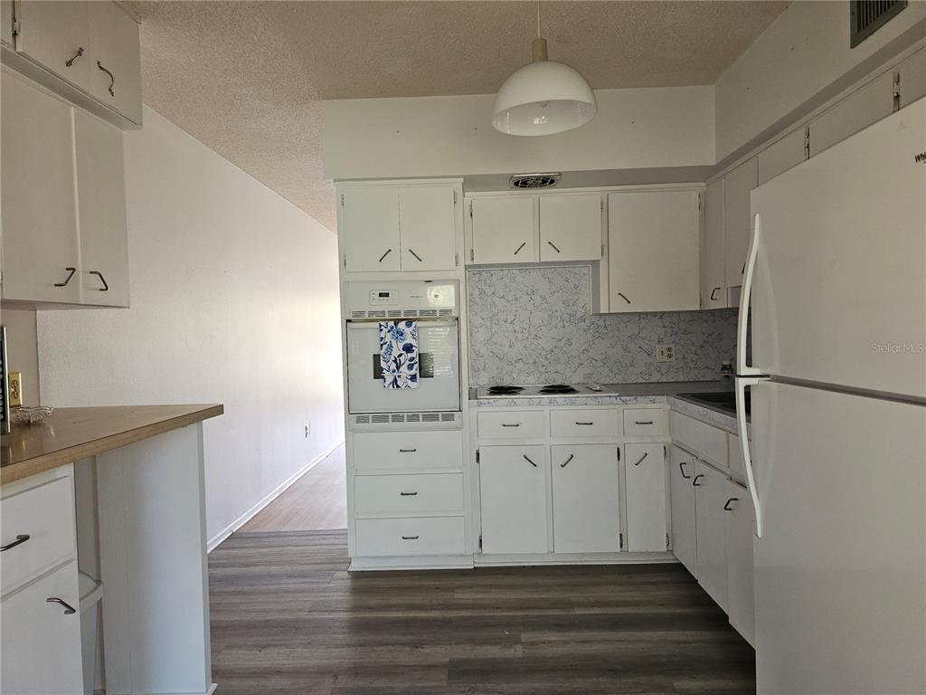 2386 Sumatran Way, Unit 44 Clearwater, FL 33763 - Photo 2 of 67 a kitchen with white cabinets and refrigerator