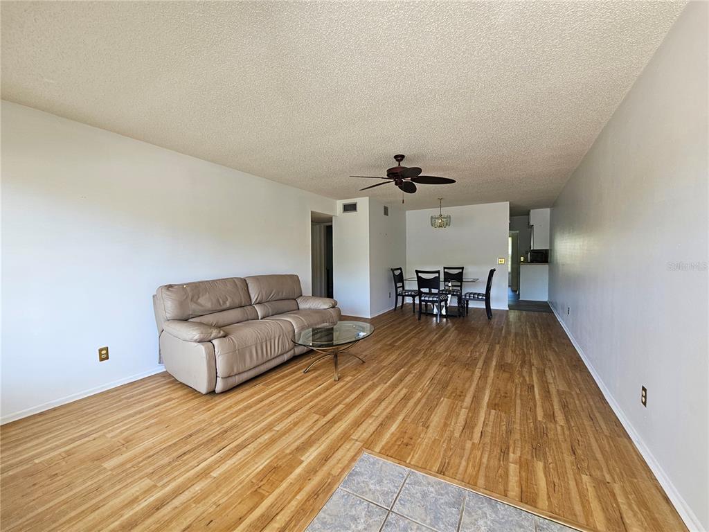 2386 Sumatran Way, Unit 44 Clearwater, FL 33763 - Photo 3 of 67 a living room with furniture and wooden floor