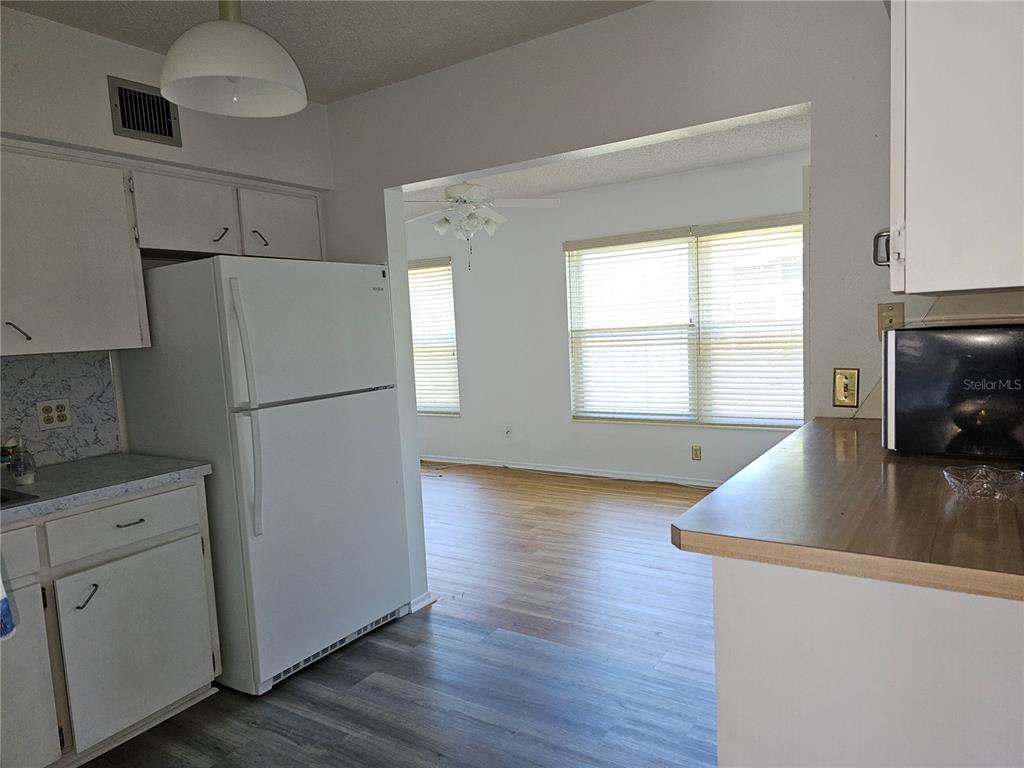 2386 Sumatran Way, Unit 44 Clearwater, FL 33763 - Photo 5 of 67 a kitchen with a refrigerator a stove a microwave and cabinets