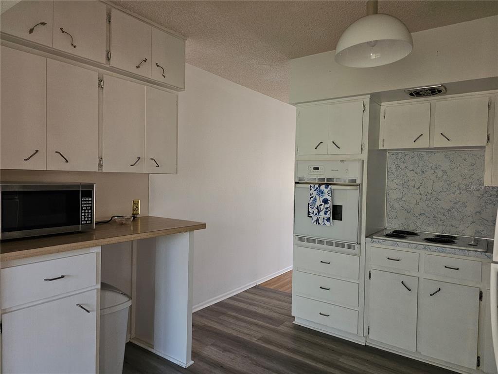 2386 Sumatran Way, Unit 44 Clearwater, FL 33763 - Photo 6 of 67 a kitchen with white cabinets and appliances