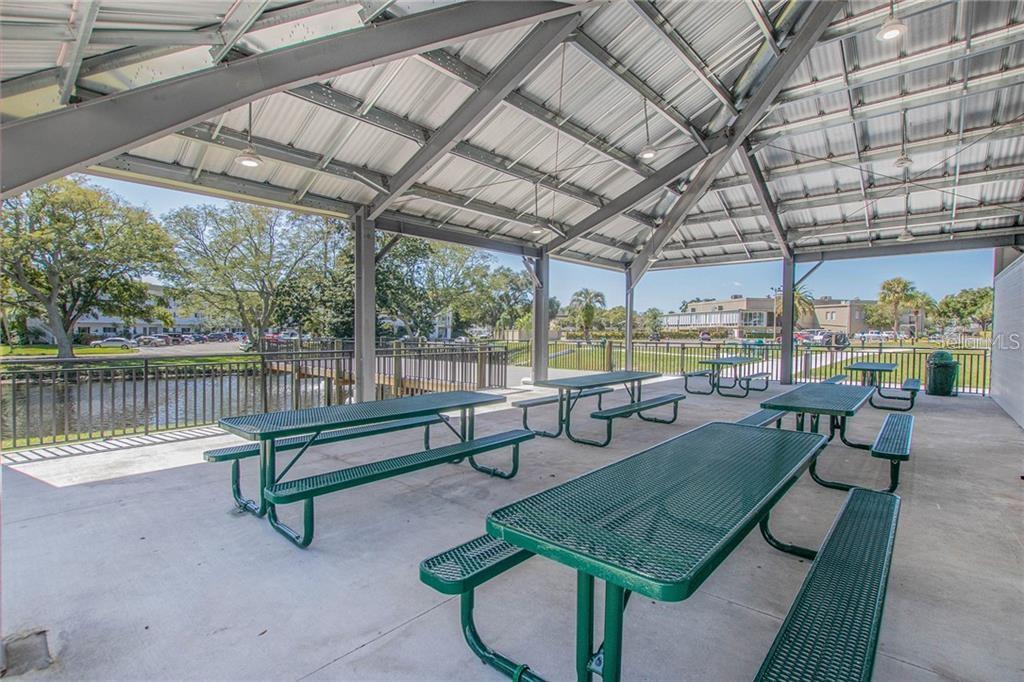 2386 Sumatran Way, Unit 44 Clearwater, FL 33763 - Photo 64 of 67 a view of a swimming pool with a couches in a patio