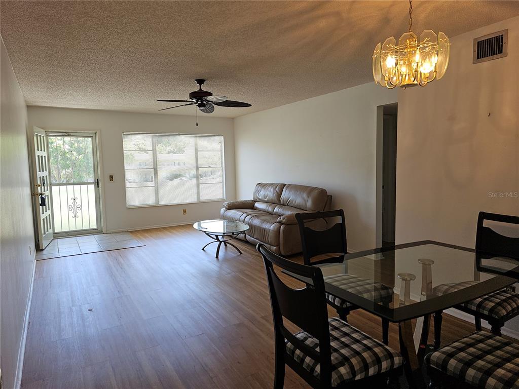 2386 Sumatran Way, Unit 44 Clearwater, FL 33763 - Photo 7 of 67 a living room with furniture and a chandelier