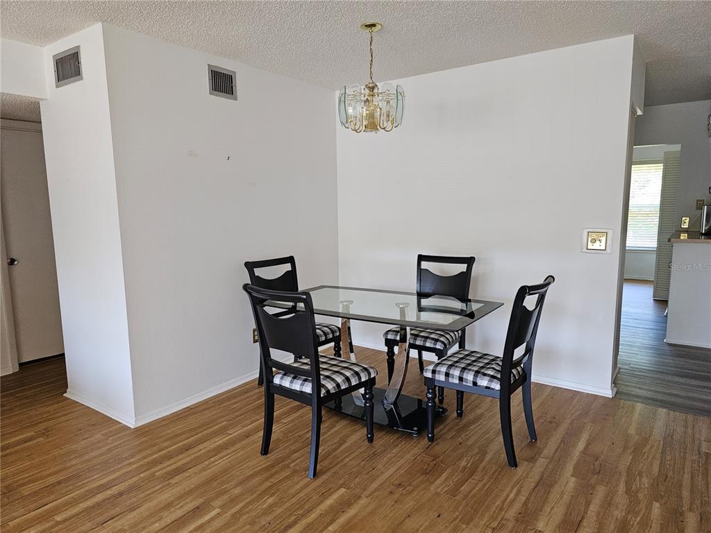 2386 Sumatran Way, Unit 44 Clearwater, FL 33763 - Photo 8 of 67 a view of a dining room with furniture and wooden floor