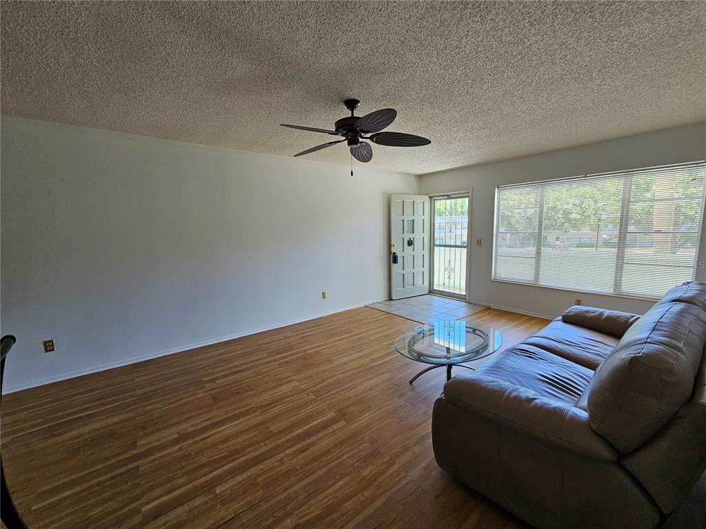 2386 Sumatran Way, Unit 44 Clearwater, FL 33763 - Photo 10 of 67 a living room with furniture and a large window