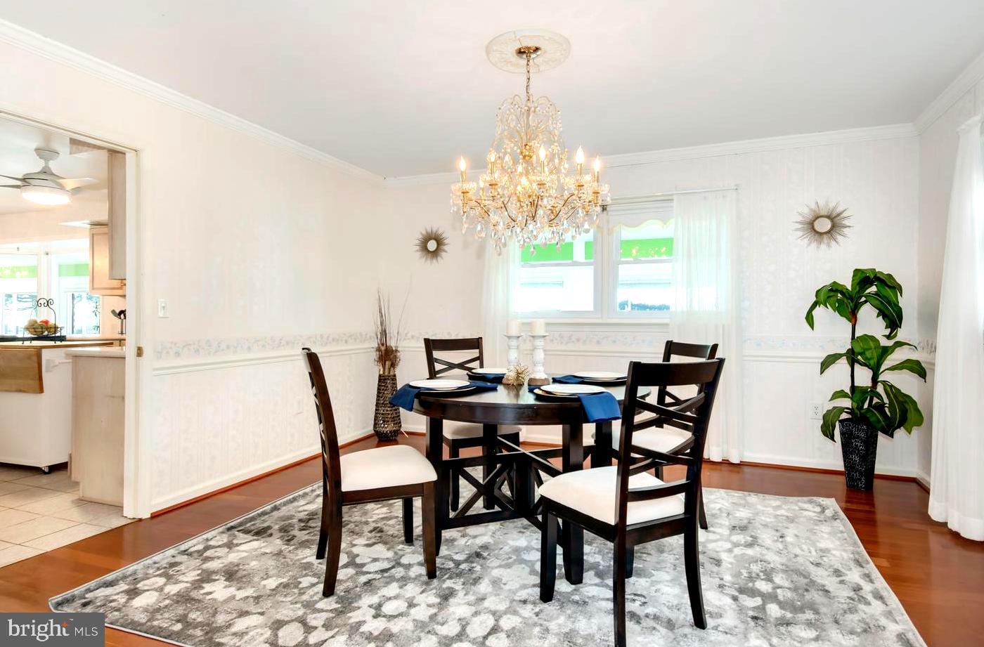 3202 Bennett Point Road Queenstown, MD 21658 - Photo 19 of 49 Chandeliered Dining Room with Chair Rail Accent