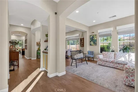 a kitchen with stainless steel appliances granite countertop a stove a refrigerator a kitchen island with a stove and white cabinets