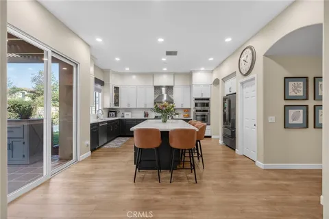 a kitchen with a sink window and cabinets