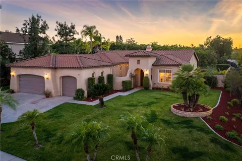 a view of a patio with couches table and chairs and potted plants