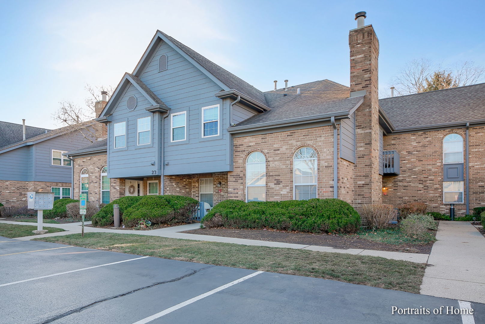 23 Foxcroft Road, Unit 115 Naperville, IL 60565 - Photo 1 of 19 a front view of a house with a garden and plants