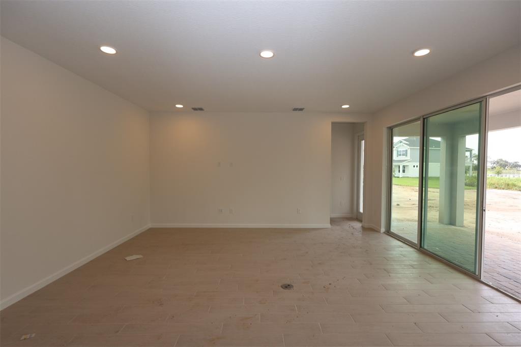 5426 Park Guell Street St. Cloud, FL 34771 - Photo 12 of 64 a view of an empty room with glass door