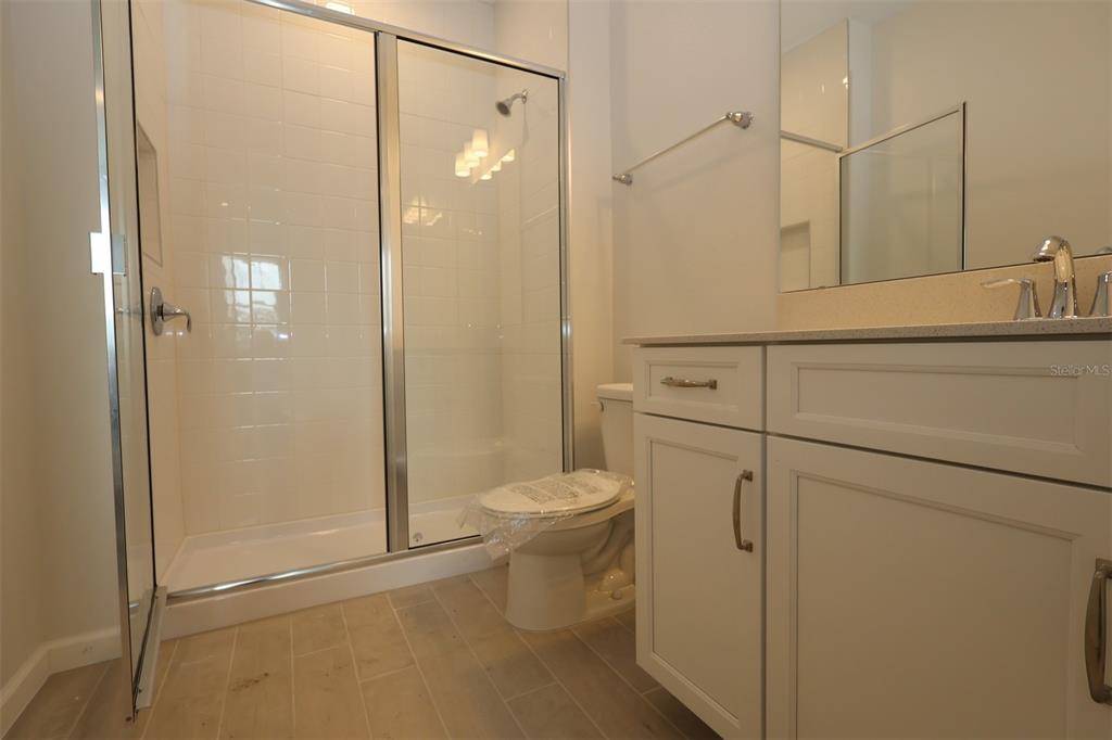 5426 Park Guell Street St. Cloud, FL 34771 - Photo 15 of 64 a bathroom with a sink a toilet and shower