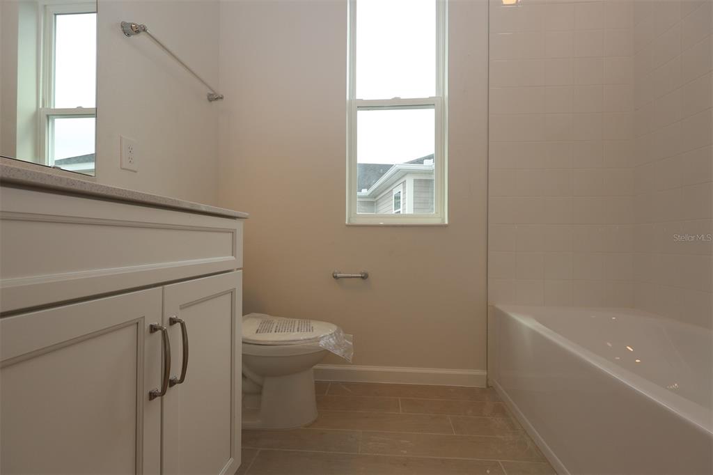 5426 Park Guell Street St. Cloud, FL 34771 - Photo 16 of 64 a bathroom with a toilet and a bathtub