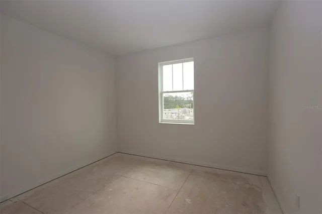 a open kitchen with white cabinets a sink and a floor to ceiling window
