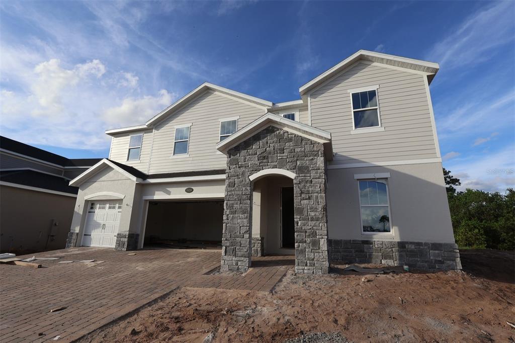 5426 Park Guell Street St. Cloud, FL 34771 - Photo 2 of 64 a front view of a house with yard and parking