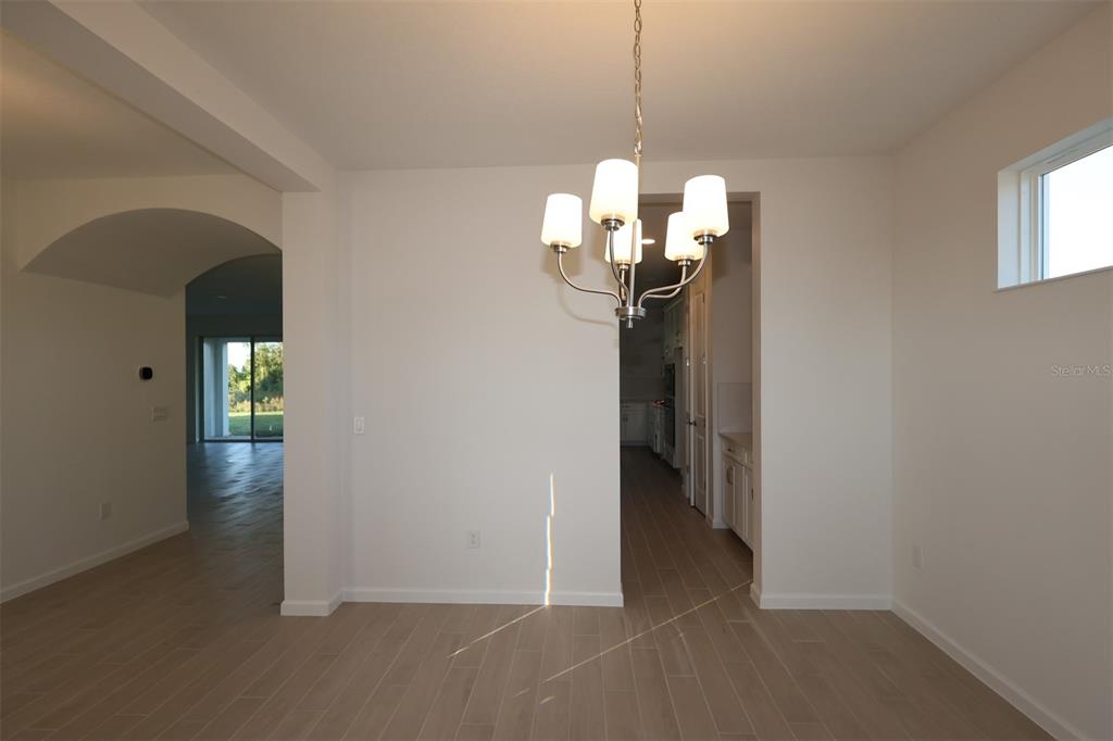 5426 Park Guell Street St. Cloud, FL 34771 - Photo 21 of 64 a view of a chandelier in big room and chandelier fan